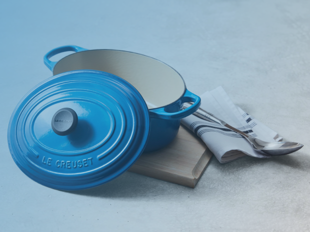 Blue Le Creuset cookware with folded linens