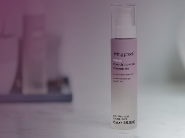Living Proof haircare products arranged on a lavender background